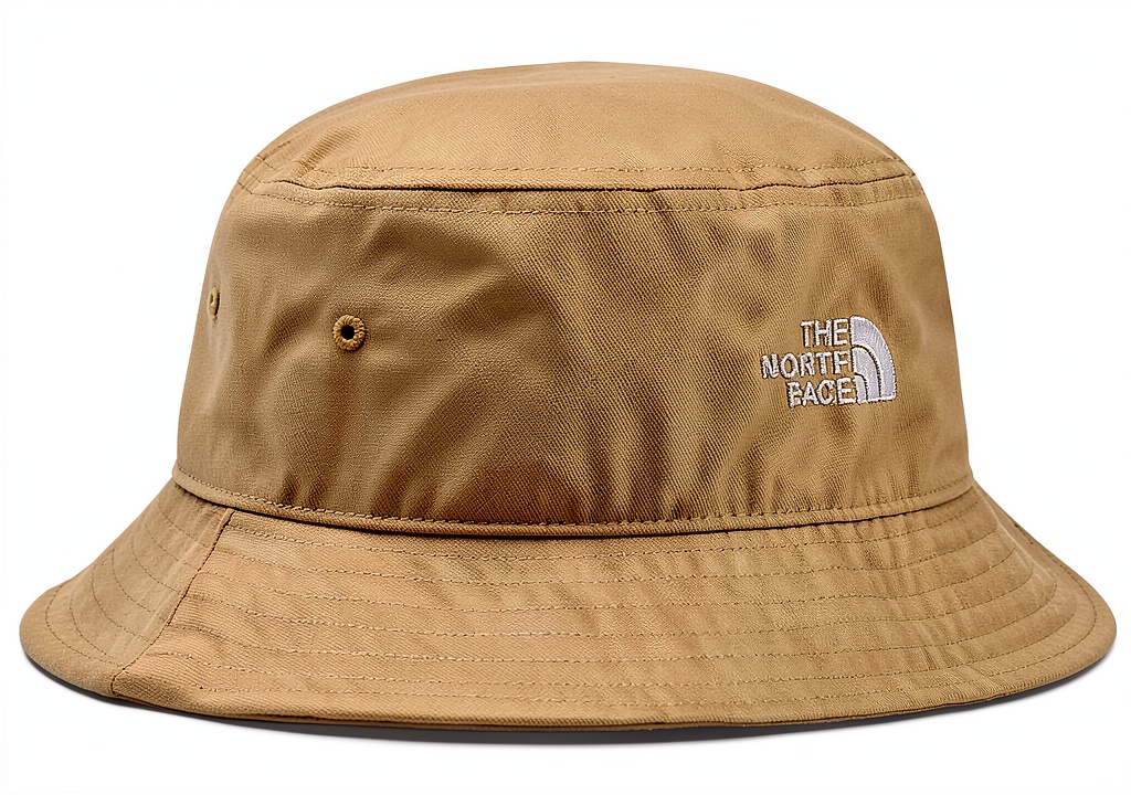 The North Face Norm Bucket Hat in White Dune color on a person hiking