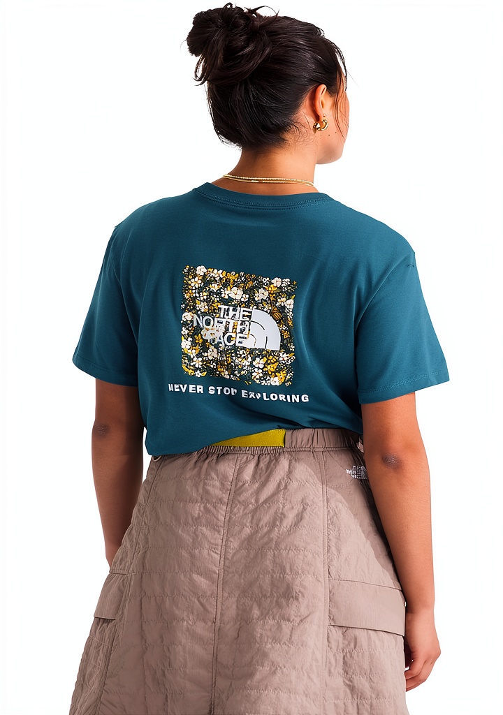 Woman wearing The North Face Floral Box tee on a trail
